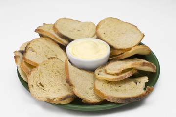 Italian bread toast with butter in a plate isolated in white background 