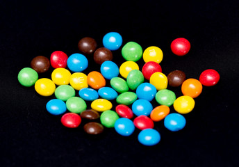 Colorful candies on black background