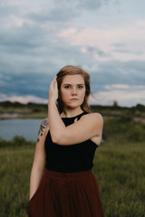 Cute Young Female Model with Short Hair and Freckles Modeling in a Bare Field