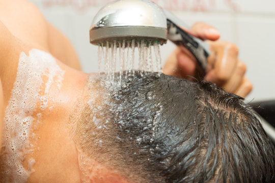 client washing head in heair cut salon