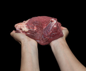 Fresh meat in a hand on a black background