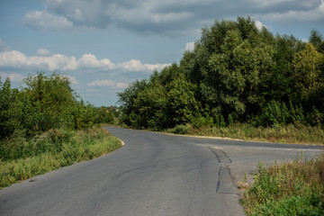 Fototapeta na wymiar Crossroads in the countryside. Fork in the asphalt road