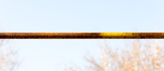 Rusty gas pipe on the background of the sky