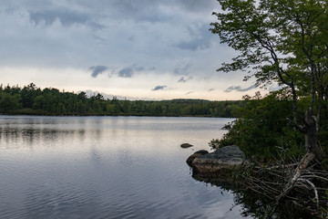 Overcast sky Lewis Lake, Nova Scotia, Canada, rocky shore, no people.