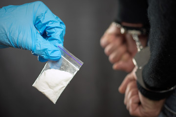  Police arrest drug trafficker with handcuffs.