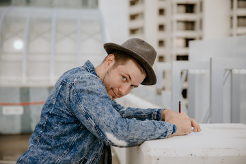Fototapeta premium Group of Young Hipster Men Modeling in Downtown Urban Parking Landscape
