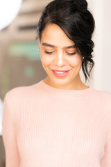 Portrait of brunette girl on pinkn sweater