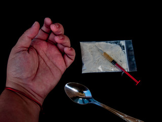 The hand of a person, drug, one spoon, and syringe. Drug concept