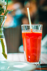 glass with tomato juice and a straw