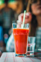 glass with tomato juice and a straw