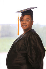  Attractive pregnant African American college graduate in cap and gown, law school graduate, law degree