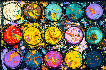 Watercolor paint palette. Colourful paint splash. Artistic background.