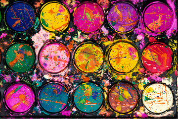 Watercolor paint palette. Colorful paint splash.