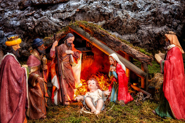 Christmas nativity scene with Holy Family in the hut and the three wise men.