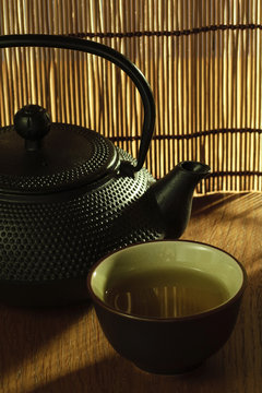 Japanese Tetsubin kettle with a cup of green tea