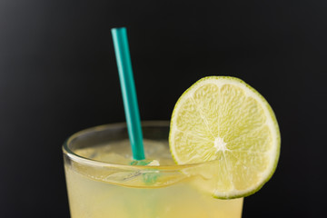 Margarita over ice with lime slice and green straw