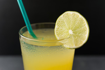 Margarita over ice with lime slice and green straw