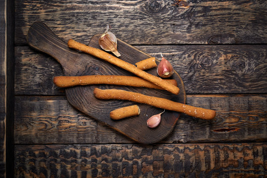 grissini and garlic on the wooden cut board