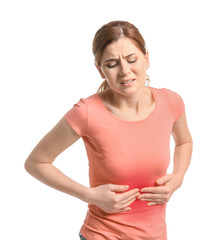 Young woman suffering from abdominal pain on white background