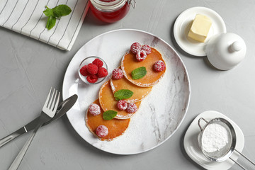 Flat lay composition with tasty pancakes and berries on table