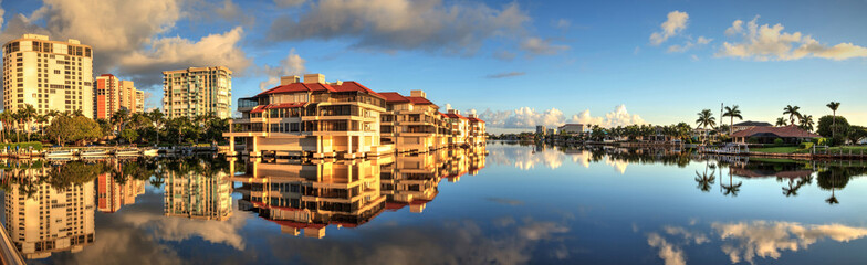 Reflection in the water of buildings along the Village at Venetian Bay