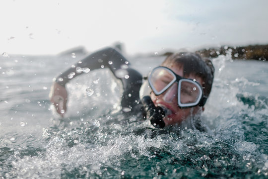 Boy Swimming In Ocean Wearing A Snorkel And Mask, Orange County, United States