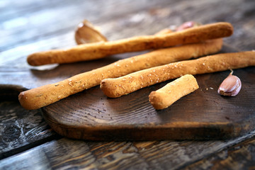 grissini and garlic on the wooden cut board