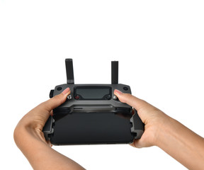 Woman hands hold remote controller landing on of new small portable drone quadcopter with mobile cellphone attache