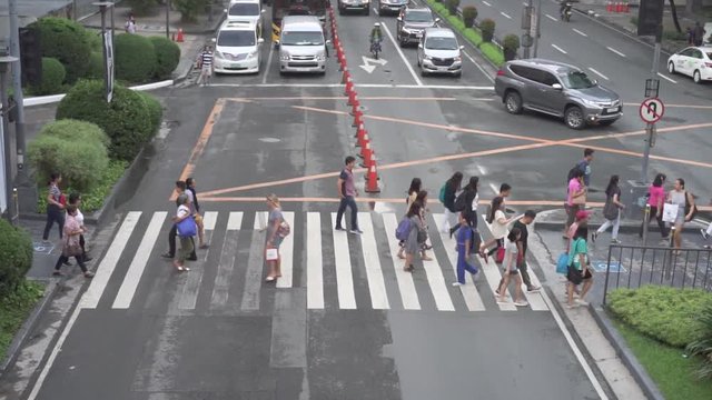Makati city of Manila, Philippines - Sept 1, 2018: People crossing the street at busy street of business district Makati city of Manila