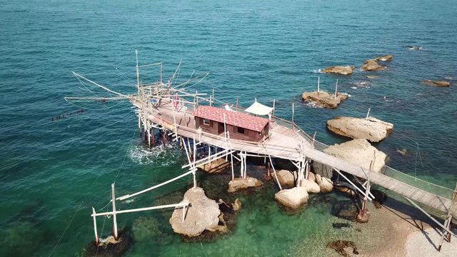 Trabocchi are a massive coastal fishing construction built from wood, which consists of a platform anchored to the rock by large logs jutting out into the sea on the Adriatic sea in Italy.