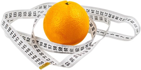 Orange with tape measurer around it - diet concept
