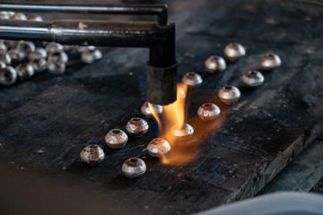 Fototapeta na wymiar melting silver in craft jewelry making, handmade silverware process.