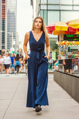 Young Eastern European Woman with long brawn hair traveling in New York City, wearing blue...