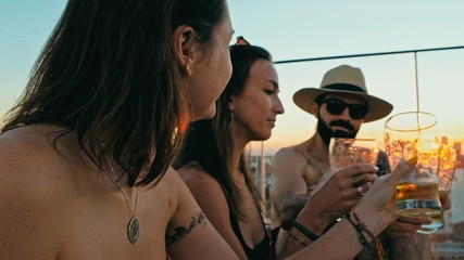 young woman and man people enjoying a beer and the company at a rooftop bar above the city with beautiful view with a cute pet dog