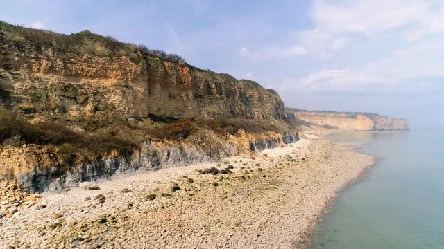 Drone footage -  close aerial shot of cliffs at Omaha Beach (D-day World War 2) in Normandy France