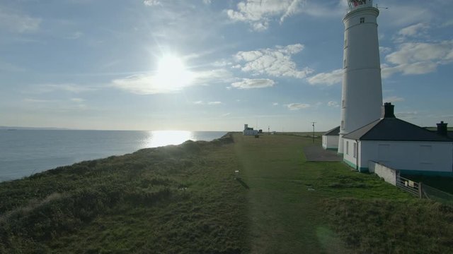 Drone footage filmed at Nash Point lighthouse during a sunset. Would make a great establishing shot