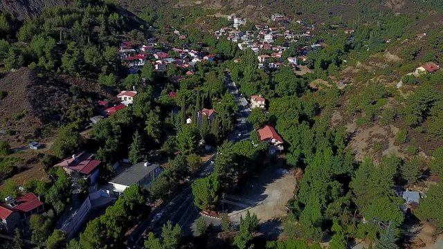 fly in reveal aerial of eastern european church and town nestled in vally