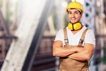 Young man in work uniform and yellow helmet