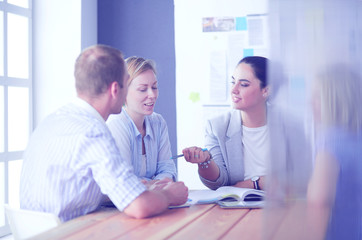Obraz premium Young people studying with books on desk. Beautiful women and men working together.