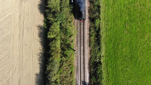 Overhead Aerial View of Stem Train on Vintage Railway Line, England. 4K Drone Footage