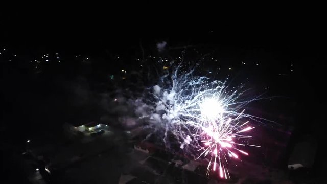 Drone shooting around fireworks in Omurtag, Bulgaria, aerial night footage, filming over the fireworks