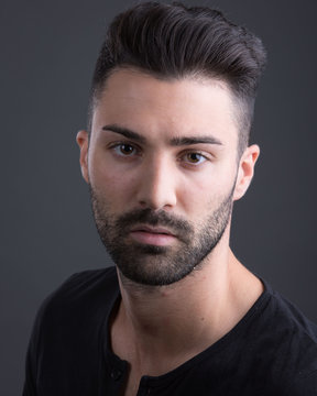 Headshot of man with stuble and grey background