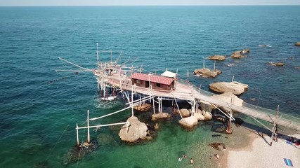 Trabocchi are a massive coastal fishing construction built from wood, which consists of a platform anchored to the rock by large logs jutting out into the sea on the Adriatic sea in Italy.