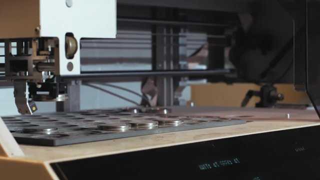 Industrial clinker Lab Testing. Machine picks a limstone raw material sample for test, 4K footage.