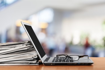 Newspapers on the laptop. Online news. Isolated