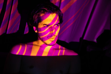 Cinematic portrait of man in yellow and purple lines, projecto