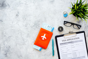 Planning a vacation, planning a trip. Visa application form near passport and airplane ticket on...