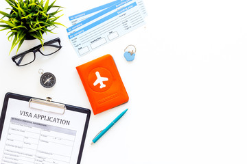 Preparing to travel. Legalize papers. Visa application form near passport and airplane ticket on...