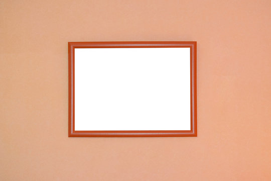 Wooden picture frame with blank white space for text on orange blurred background
