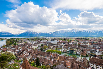 Aeria Scenery of Old Town Cityscape from Thun Castle and Alpine Mountain Range in Switzerland with Cloudy. Swiss Village among Swiss Alps. Scenic Landscape of Switzerland Country with Snowy Mountain.